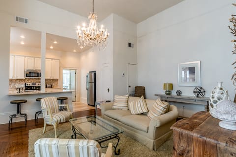 Elegant living room open to kitchen. Table opens up for dining.