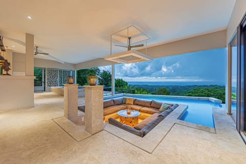 Elegant sunken lounge beside infinity pool with breathtaking views