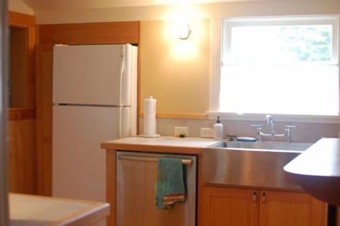 Kitchen features new salvage fir cupboards built on-site and marmoluem floor.