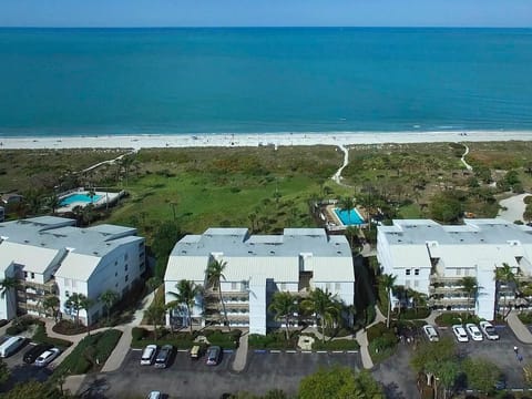 shows two of the three pool with the beach villas buildings & plenty of parking
