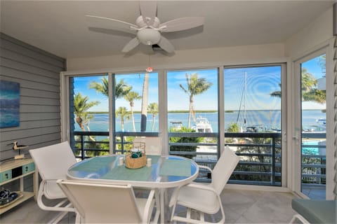 Enclosed glass lanai overlooking bay. 