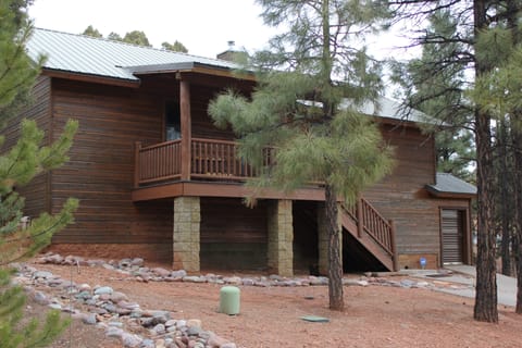 Front of the cabin with a covered deck to enjoy your coffee 
