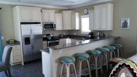 Kitchen and Bar seating area. Ample space for food prep, and Dining.