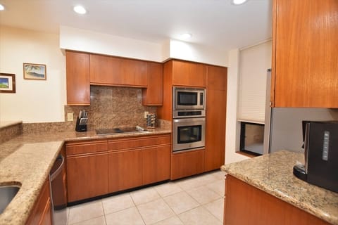 Kitchen features granite counter tops and new appliances.