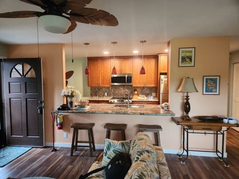 View of Breakfast bar and kitchen, from living area. Unit entrance to left