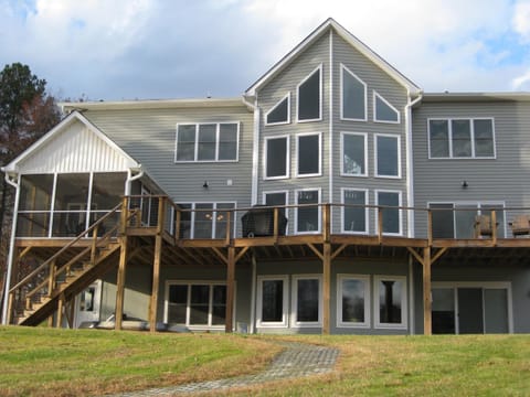 Back of house with path to lake