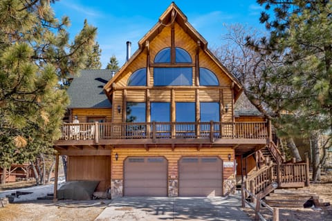 Welcoming cabin entry surrounded by towering pine trees, offering fresh mountain air and a peaceful forest setting—the perfect first impression for your Big Bear Lake getaway.