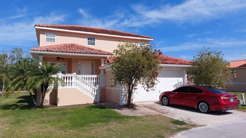 Driveway entrance with two car garage.