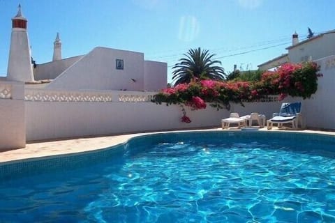 Swimming pool, villa in the background