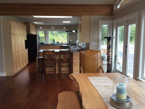 Lg Canadian Maple custom dinner table~in front of window.  Open concept kitchen