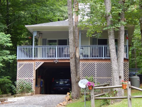 Front of house in summer showing covered parking.