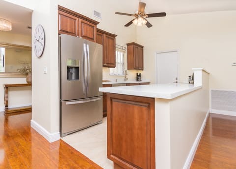 Kitchen fridge with ice water plenty of cooking  utensils  dishes and silverware