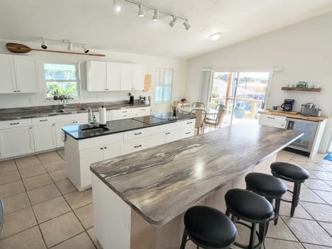 Chef's delight, Kitchen open to living area, doors to the deck overlooking pool