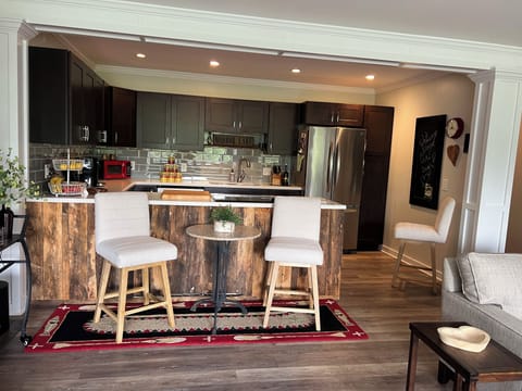 Kitchen area with extra seating and bar cart.