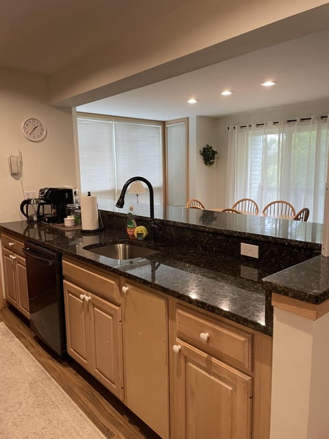 Granite counters, with bow breakfast bar. Facing sink, prep area, dishwasher.