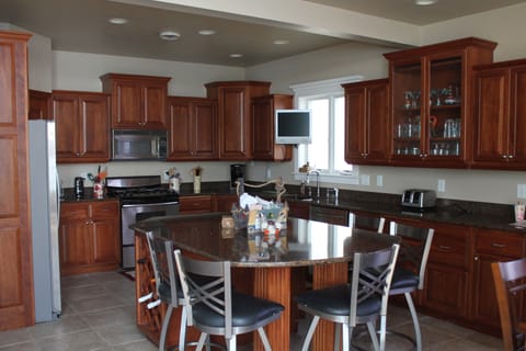 Kitchen with stainless steal appliances, granite counter tops. Lots of seating 