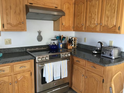 Five burner GE café stove with warming drawer. Caphalon SS cookware set.