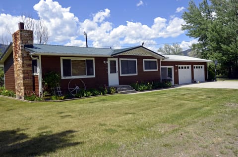 Front of house also showing sliding glass door which goes into a indoor porch.

