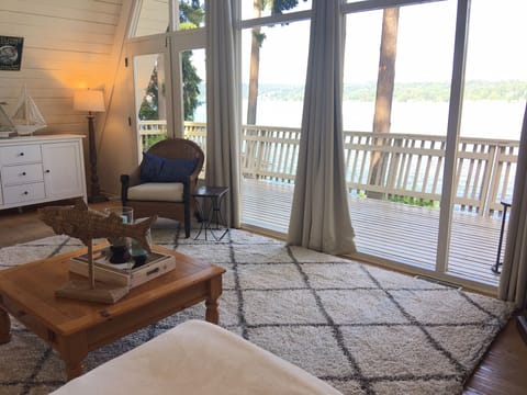 View from the sofa in the living room. Deck continues left toward outdoor dining