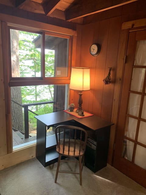 There is a desk for a workspace in the living room.