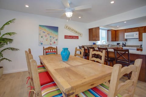 Large family dining table sits adjacent to the kitchen on one side and living room on the other. Perfect for meals, game nights and great conversation!