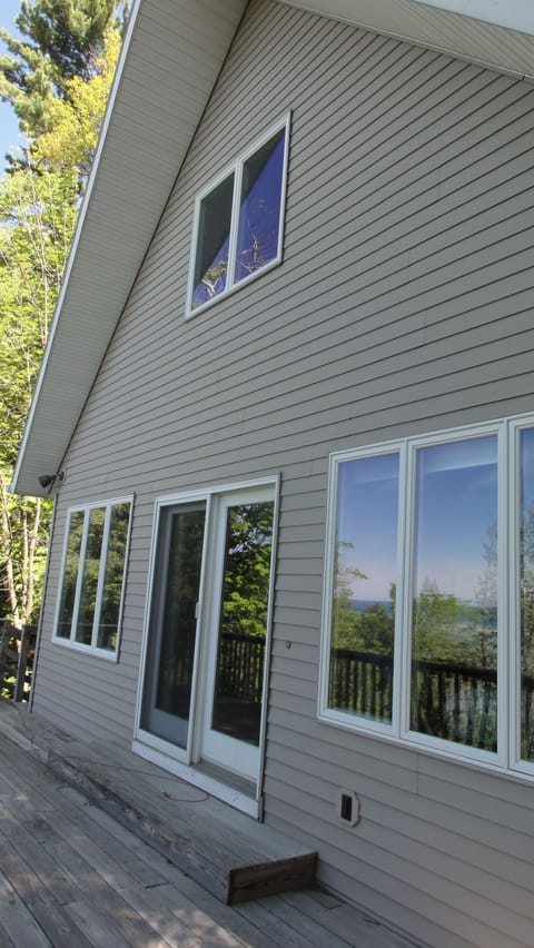 South side of cottage facing Lake Michigan and oversized deck.
