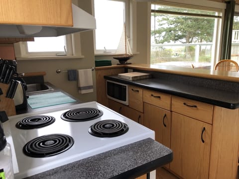 galley kitchen with bar and stools