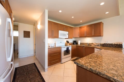 Fridge on left side next to washer/dryer cabinet