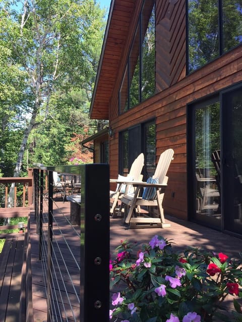 Large deck facing sunset. Enjoy the lake sitting on By the Yard rocking chairs.