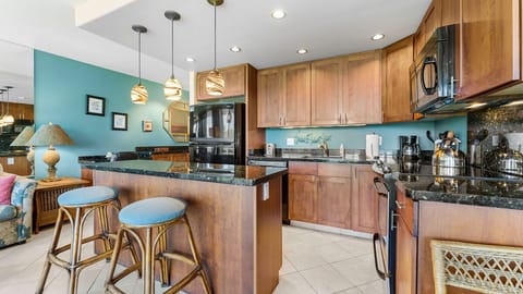 KItchen well equipped with stainless and black appliances.