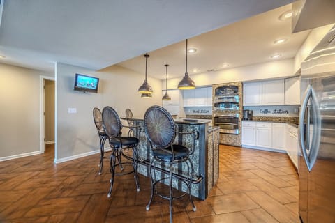 This stylish kitchen with a cozy breakfast bar is perfect for casual dining.