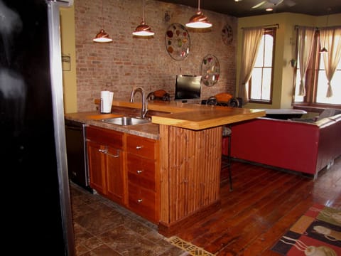 View of kitchen and living-room from the hallway. Loft beds are located above.