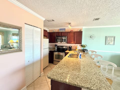 Kitchen with eat in countertop and 3 barstools 