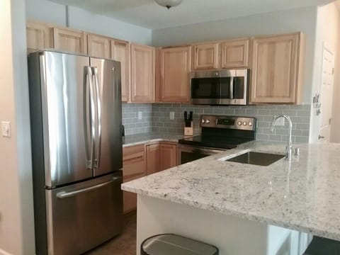 Well equipped kitchen with new appliances and countertops