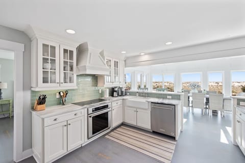 Kitchen is equipped with stainless steel appliances and has ocean views