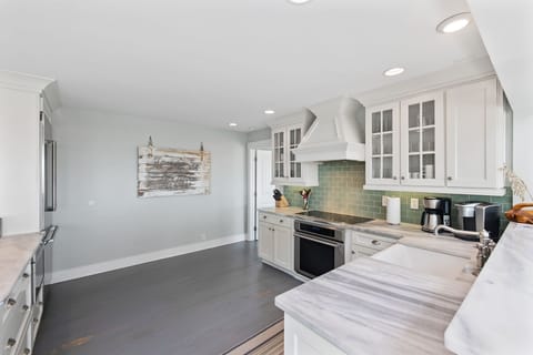 Kitchen is equipped with stainless steel appliances and has ocean views