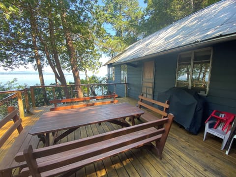 Deck with large table, grill, lake and mountain views.