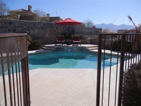 Gated pool, lounge chairs, side tables, umbrellas, luxurious towels and floats.