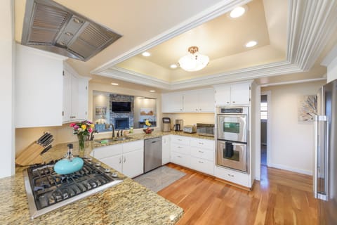 Stainless steel appliances and view into the living room from the kitchen