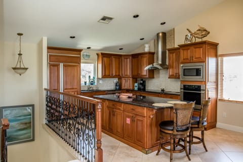 Kitchen with large center island, granite countertops and GE Monogram appliances