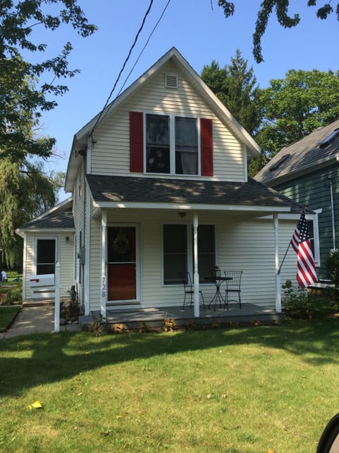 Cheerful cottage exterior with covered front porch- perfect for morning coffee
