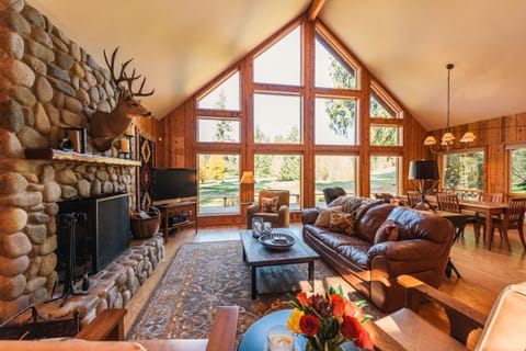 Great room with wall of windows overlooking golf course