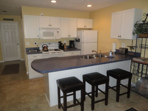 Fully stocked kitchen including microwave, dishwasher and breakfast bar.