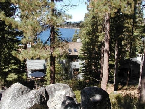 overall view of the home, backyard and lake