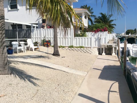 view of canal side of unit showing yard and dock