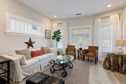 Designer living room, 9 ft ceilings. Adjacent front porch for lounging.