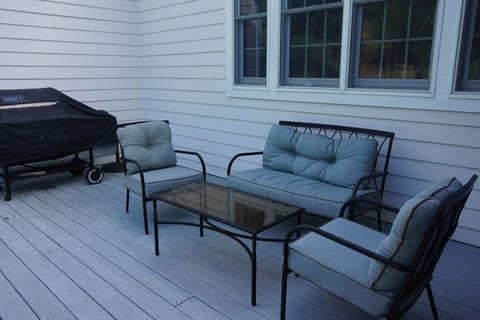 Deck next to screened porch has gas grill with convenient built-in gas line.