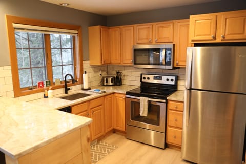 Updated kitchen with stainless steel appliances and granite counters.