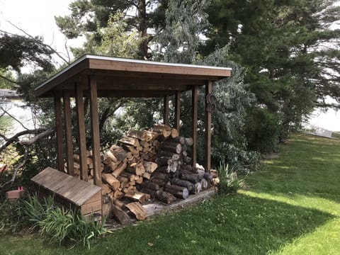 Fire wood supply w/ closed box for fire starting stuff & horse shoes on right.