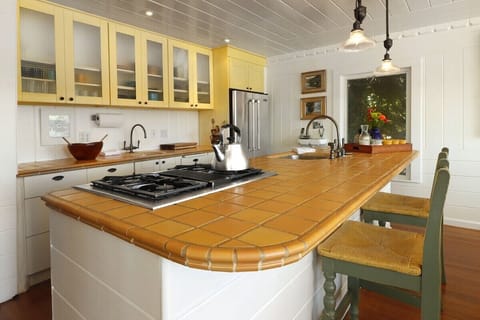 The kitchen is just off the dining room and shares the view. It is fully equipped with all the pots & pans everything else you should need. There is plenty of colorful Fiesta dishes to mix & match and ample silver wear for a lovey place setting. 